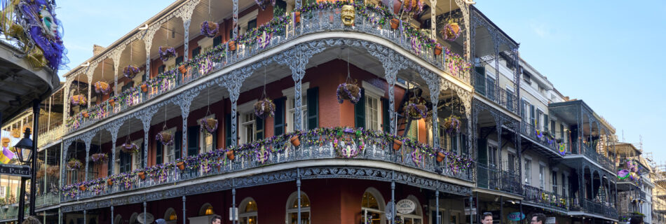 A historic building called the La Branche House in the french quarter with people walking past